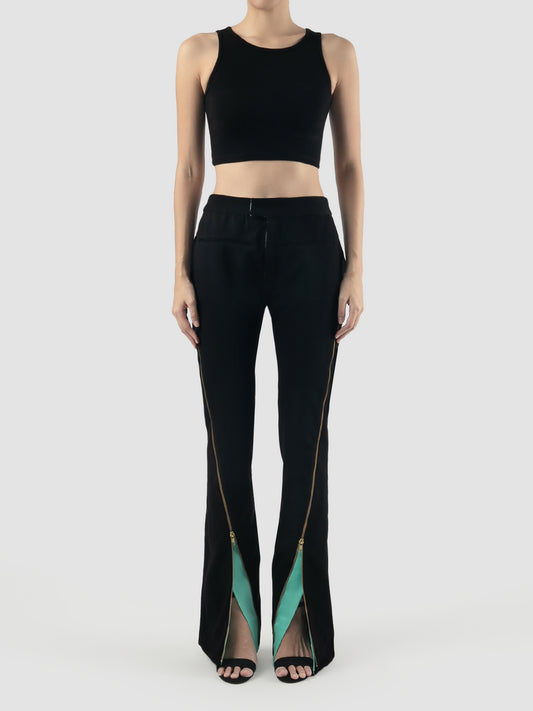 Black tailored pants with zipper and mint facing details