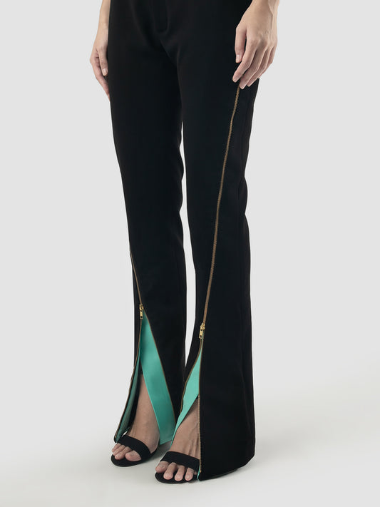 Black tailored pants with zipper and mint facing details