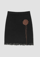 Black knit mini skirt with sun crochet applique