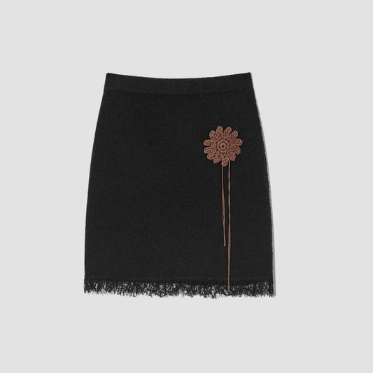Black knit mini skirt with sun crochet applique